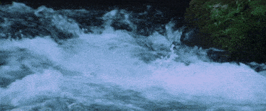 a river with a lot of water coming down the cliff