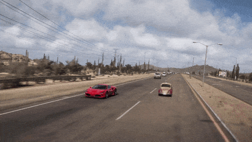 a red sports car driving down a desert road