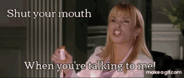 a woman is holding a bottle of pills and says shut your mouth when you 're talking to me !