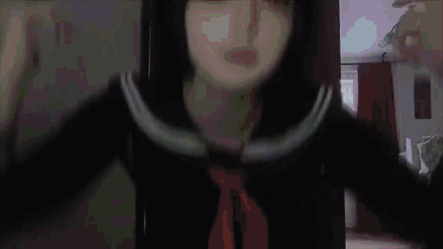 a girl in a sailor suit is making a funny face in a room .