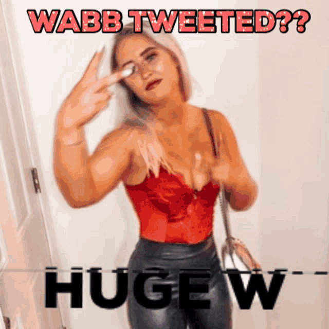 a woman in a red top with the words wabb tweeted huge w below her