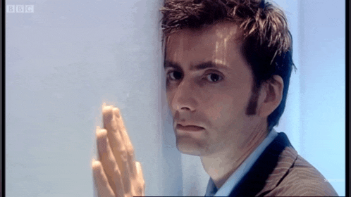a man leaning against a wall with bbc written on the bottom of the screen