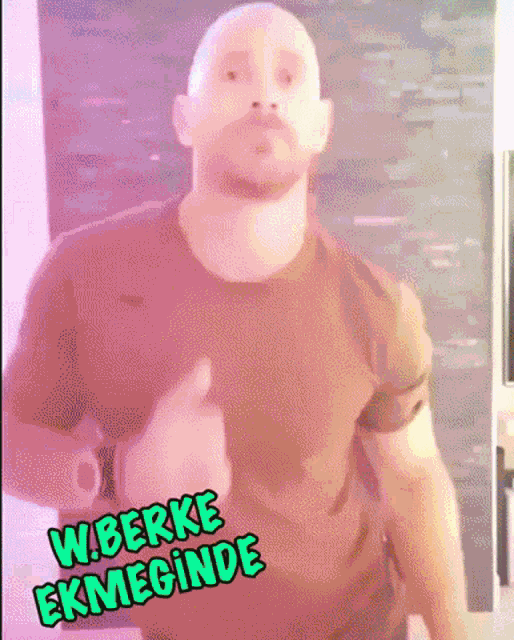 a bald man with a beard is wearing a t-shirt that says wberke ekmeginde on it