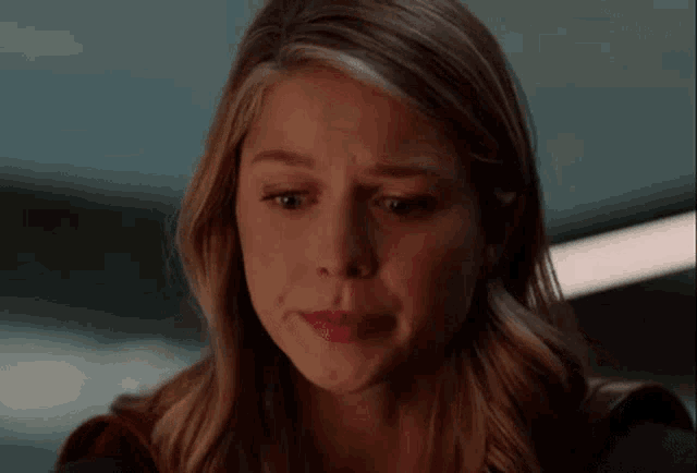 a close up of a woman 's face with a tear running down her face .