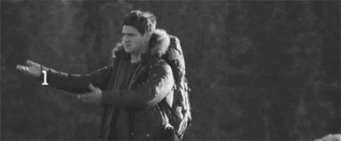 a black and white photo of a man with a backpack and the words `` like i '' above him .