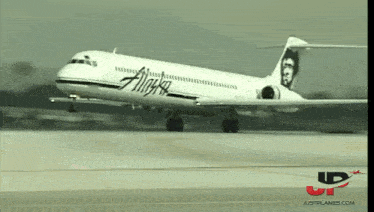 an alaska airlines plane is taking off from an airport runway
