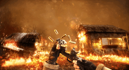 a person holding a gun in front of a fire