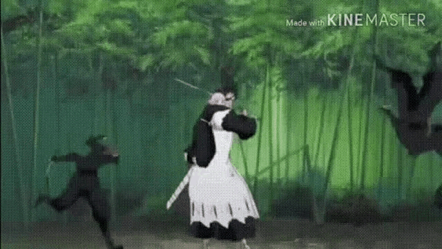 a man in a kimono is standing next to a man in a black suit in a bamboo forest .