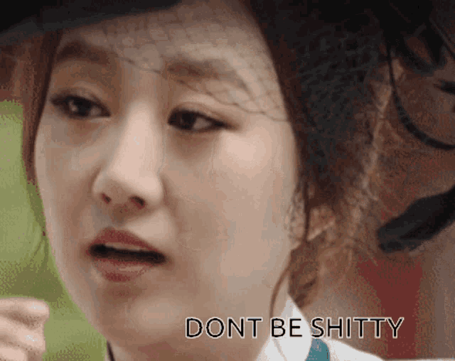 a close up of a woman 's face with the words " dont be shitty " on the bottom