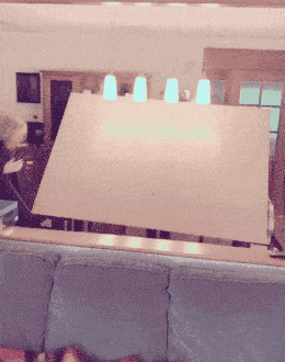 a large piece of cardboard is sitting on top of a blue couch