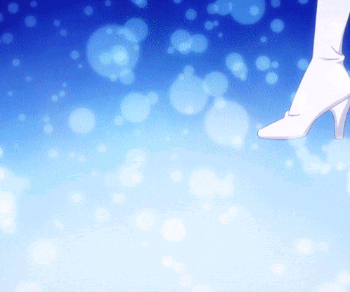 a woman 's foot in a white high heel against a blue background