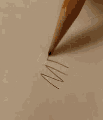 a pencil is being used to draw a circle on a piece of paper