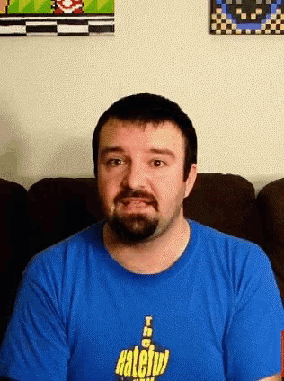 a man is wearing a blue shirt that says hateful