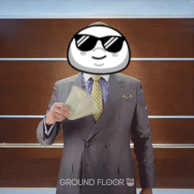 a man in a suit and tie is holding a piece of paper in front of a wall that says ground floor on it
