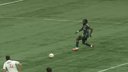 a group of soccer players are playing on a field with a telus ad behind them
