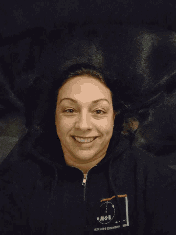 a woman is wearing a black shirt that says mc-sh on it