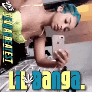 a woman with blue hair is taking a picture of herself with the words self greatest lil banga