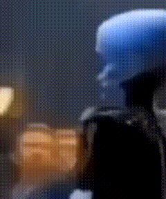 a blurred image of a person with a blue head and a black jacket