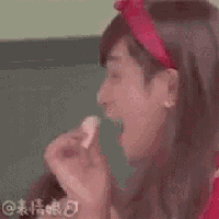 a close up of a person wearing a red dress and a red headband with chinese writing on it .