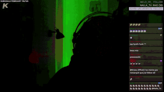 a man wearing headphones stands in front of a microphone in front of a sign that says keep calm