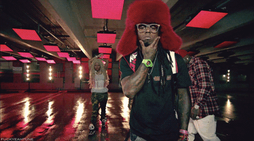 a man wearing a red hat and glasses stands in a room