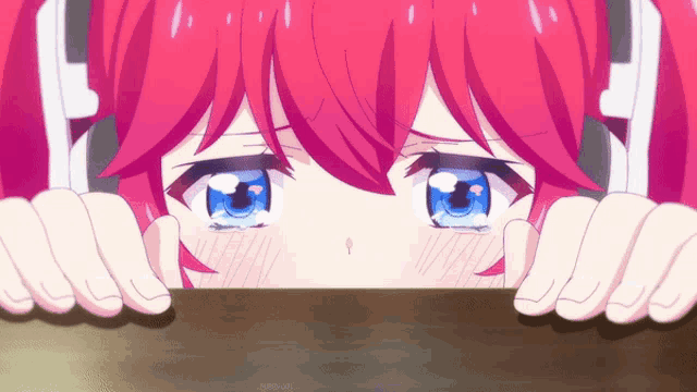 a girl with red hair and blue eyes peeking over a table