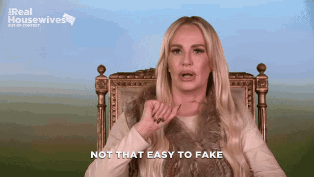 a woman sitting in a chair with the words " not that easy to fake " in front of her