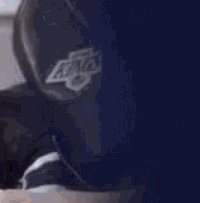 a close up of a person wearing a baseball cap on a plane .