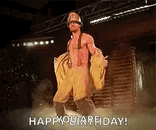 a man in a fireman costume is dancing on a stage and says happy you are friday .