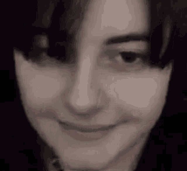 a close up of a person 's face with a smile on it .