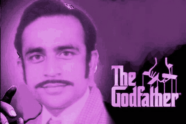 a man with a mustache is smoking a cigarette in front of the godfather logo