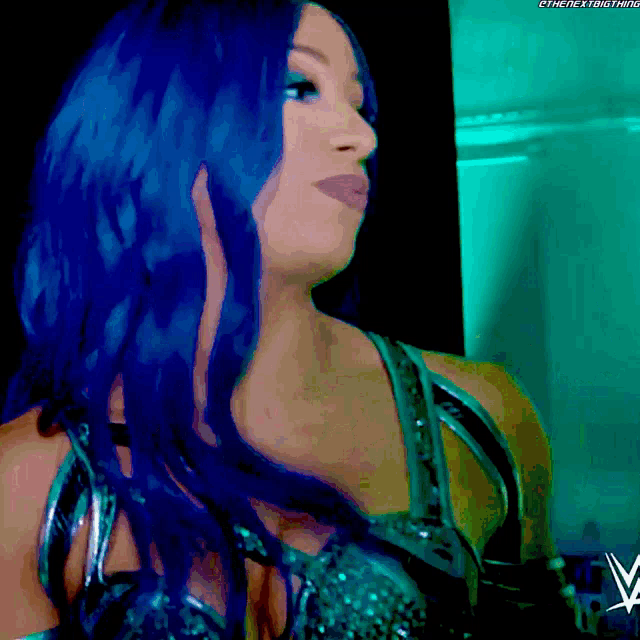a woman with blue hair is wearing a wrestling outfit