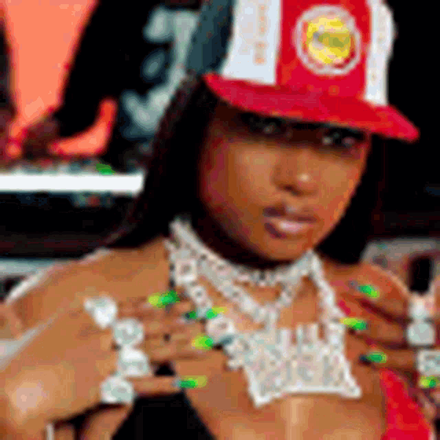 a woman wearing a red and white hat and a necklace is standing in front of a piano .
