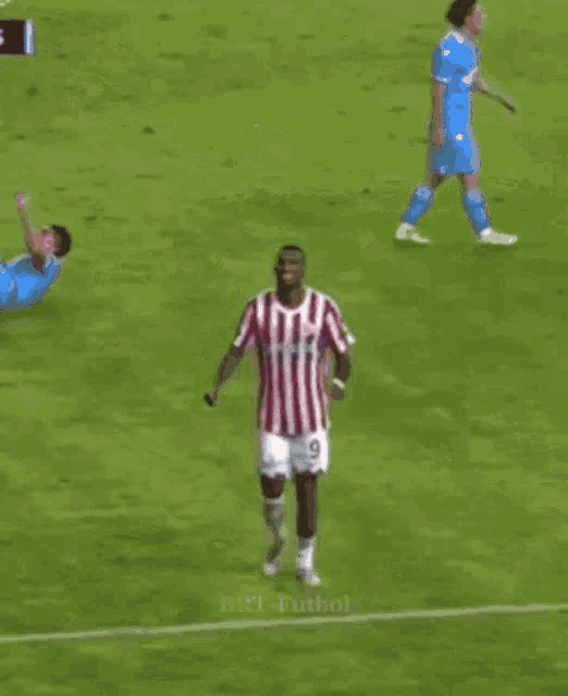 two soccer players wearing red and white striped shirts with the number 9 on the shorts