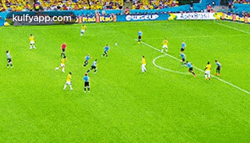 a group of soccer players are playing a game on a field sponsored by kulfyapp.com .