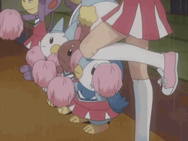 a group of cheerleaders are holding a stuffed animal in their arms