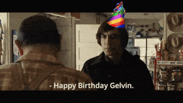 a man wearing a rainbow hat says happy birthday gelvin