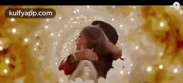 a man and a woman are flying through the air in a christmas scene .