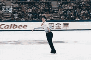 a man is ice skating in front of a calbee banner