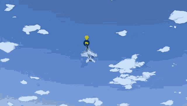 a jet is flying through a blue sky with a yellow balloon attached to it