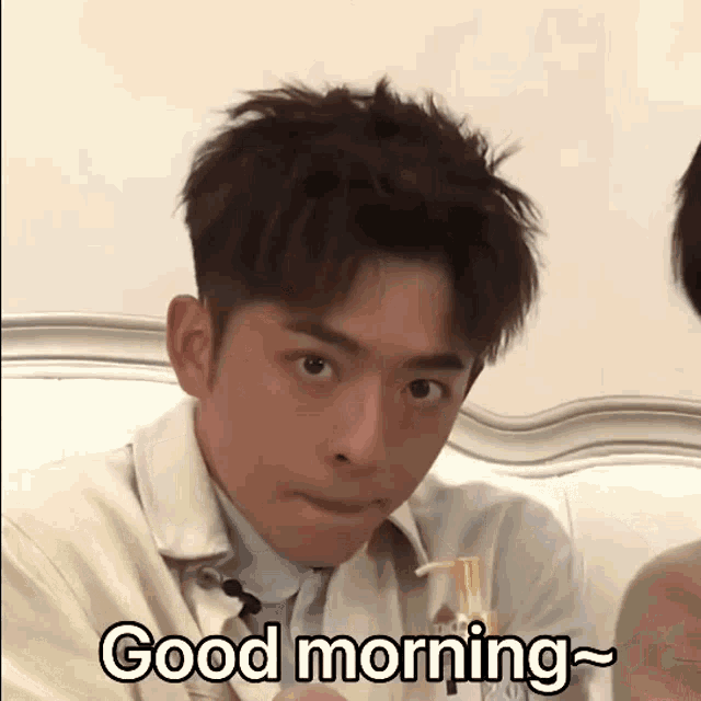a young man is making a funny face and saying good morning