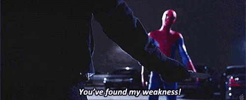 a man is holding a knife in front of a spiderman who says you 've found my weakness