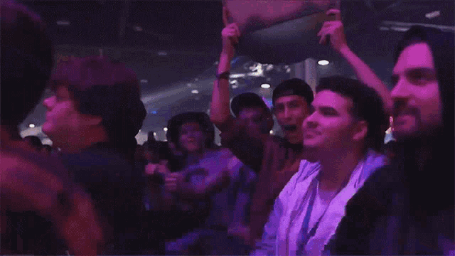 a crowd of people watching a concert with one man holding up a sign that says ' i love you '