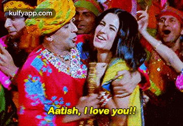 a man in a turban is hugging a woman and says `` aatish , i love you ! ''