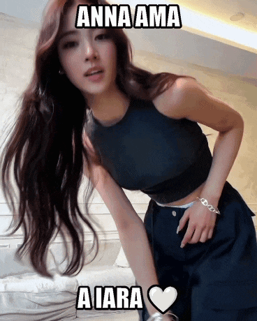 a woman with long hair is wearing a black crop top and black pants with the words anna ama aiara written on it