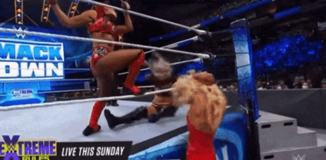 two women are wrestling in a wrestling ring with the words extreme rules on the bottom