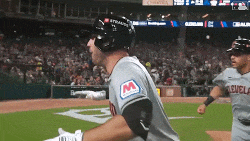a baseball player wearing a helmet with the letter m on it