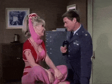 a man and a woman are standing next to each other in a room .