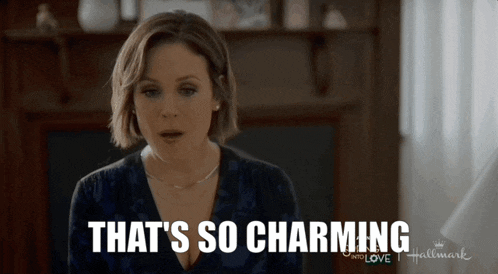 a woman says that 's so charming in front of a hallmark logo
