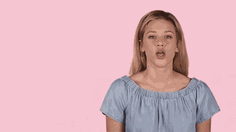 a woman in a blue off the shoulder top points up